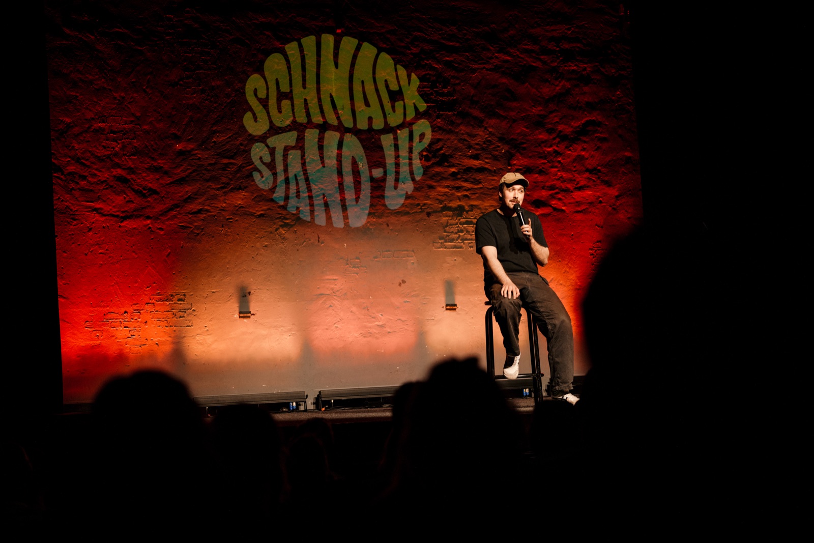 Comedian vor leuchtender SCHNACK-Wand